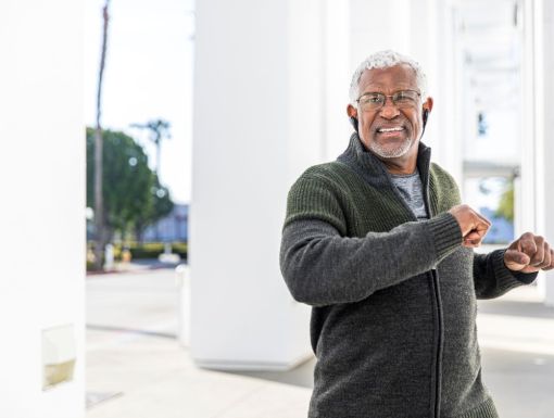 Older man preparing to exercise outdoors