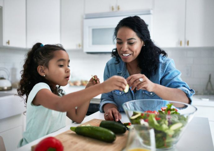 Mother daughter making food