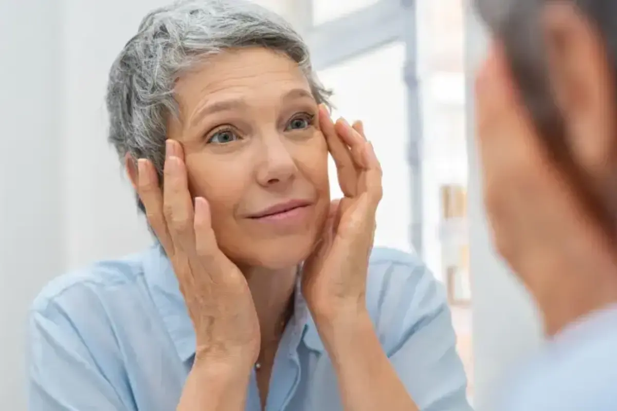 older woman looking in mirror