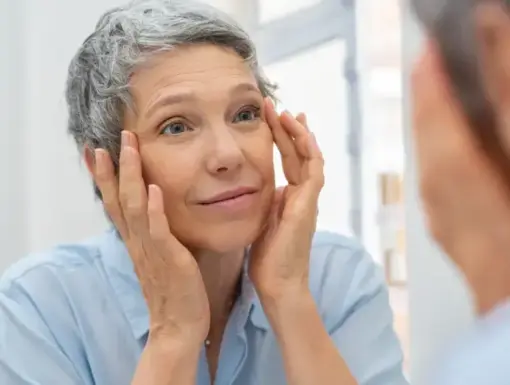 older woman looking in mirror