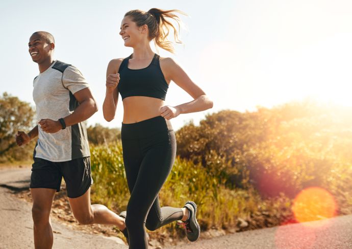 man and woman running outside