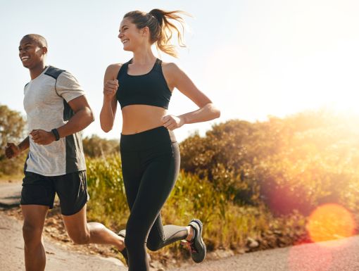 man and woman running outside
