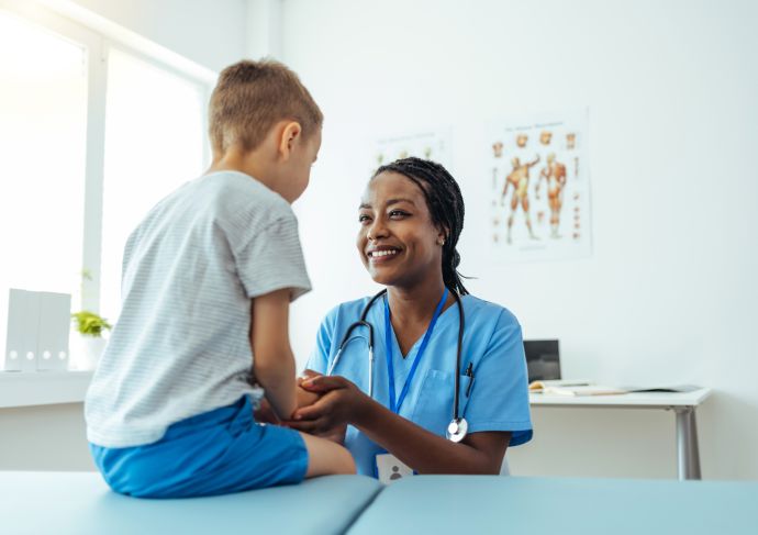 Young boy smiling with pediatrician