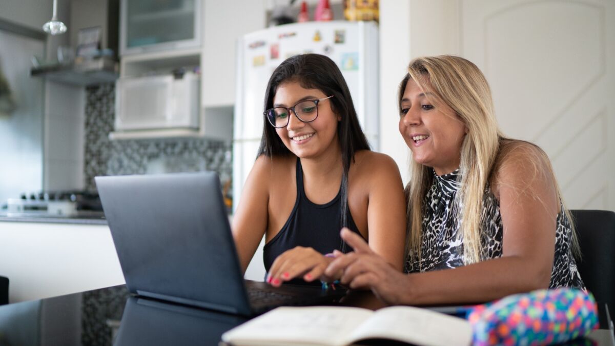 Mom and teen looking at laptop