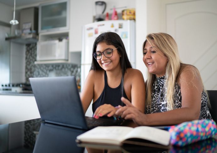 Mom and teen looking at laptop