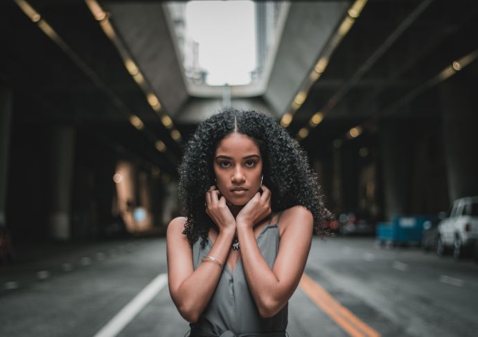 Young woman with anxiety standing on a street