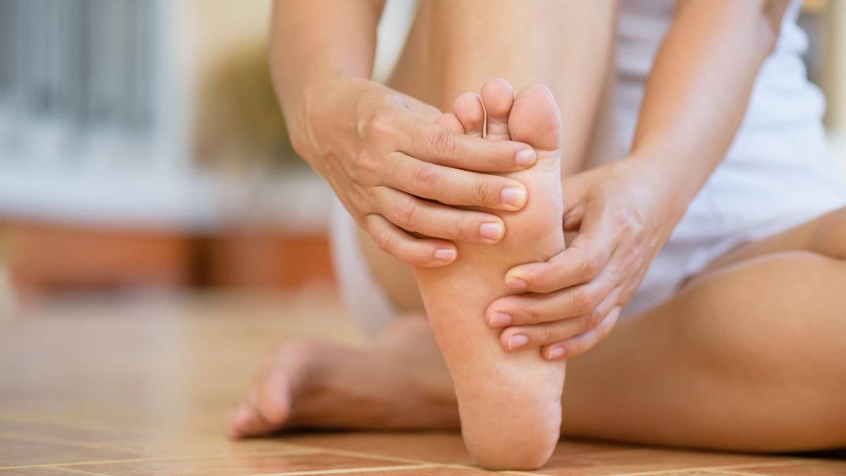 Woman holding foot