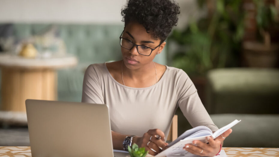 Women Looking at Computer writing notes