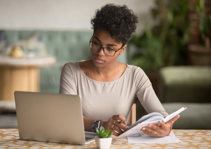 Women Looking at Computer writing notes