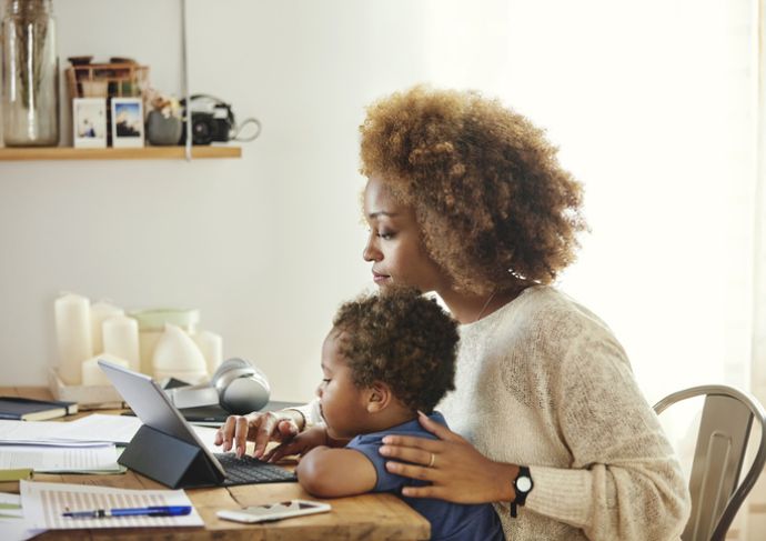 Mom looking at computer with Child