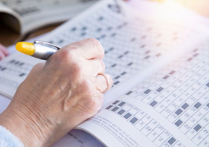 Senior woman doing crossword puzzles