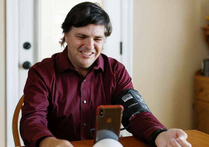 Man-at-table-taking-blood-pressure