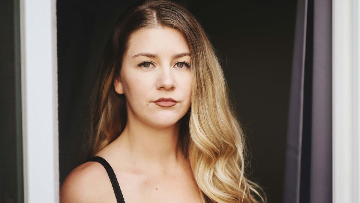 Young woman wearing tank top looking serious