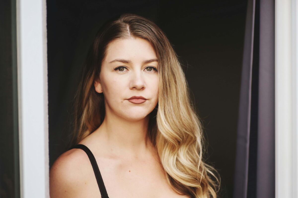 Young woman wearing tank top looking serious