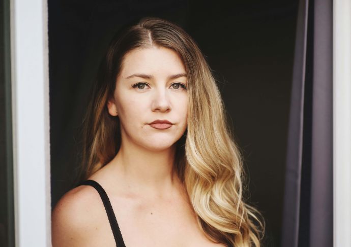 Young woman wearing tank top looking serious
