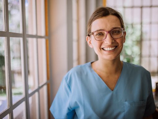 Happy nurse in scrubs