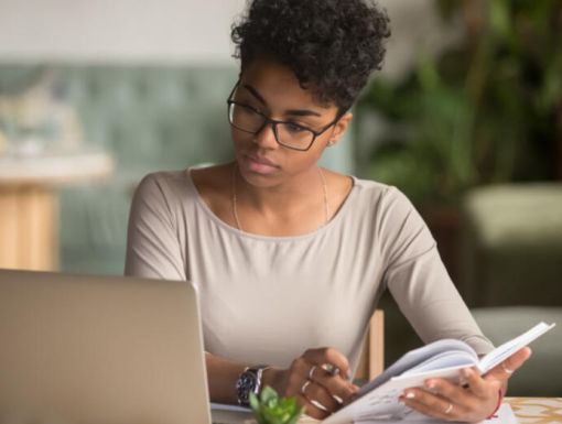 Women Looking at Computer writing notes 1