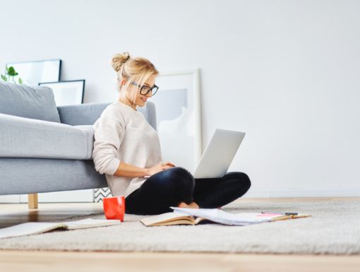 Women wearing glasses doing research on her computer