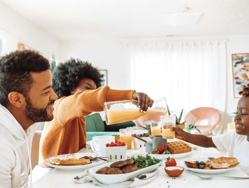 Family of three eating breakfast