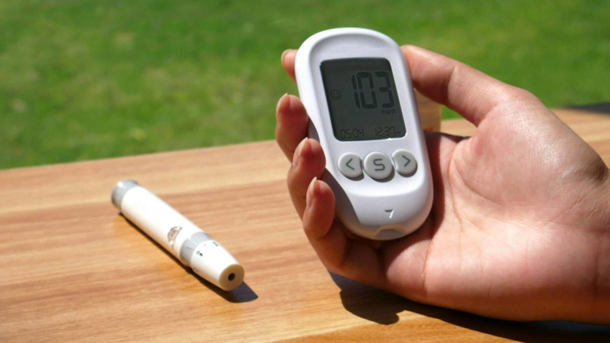 Woman holding device to check blood sugar