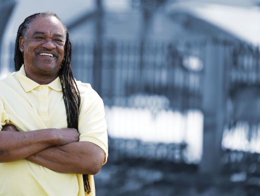 Smiling man standing with arms crossed
