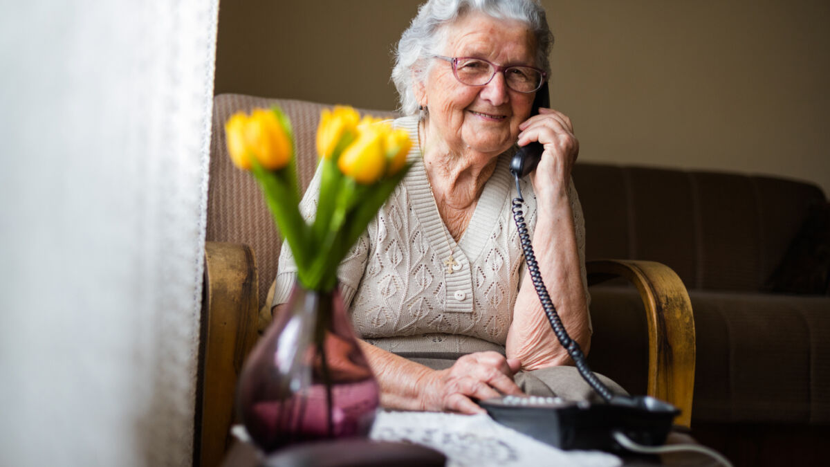 Happy elderly woman on phone