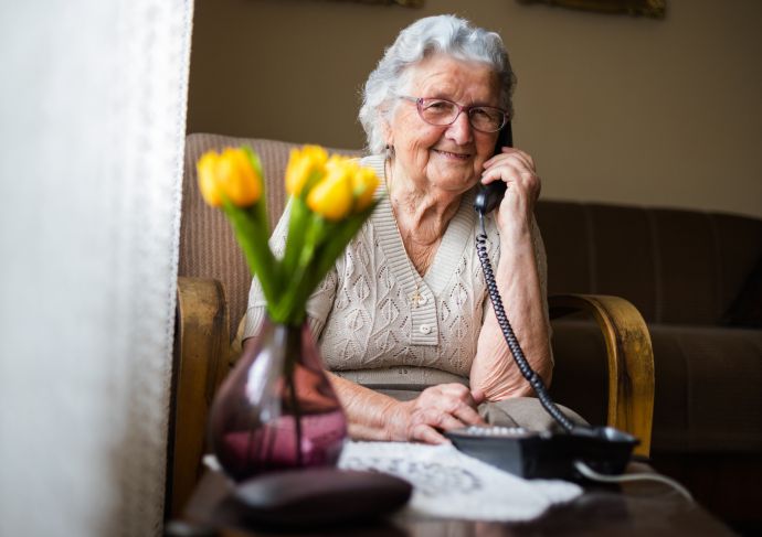 Happy elderly woman on phone