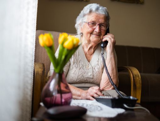 Happy elderly woman on phone