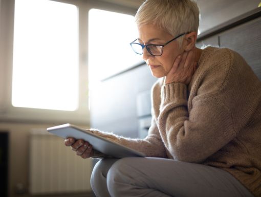 Women thinking looking at ipad