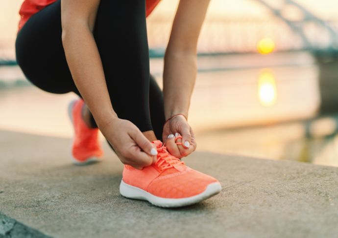 Tying up running shoes outside