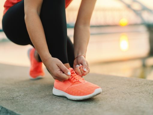 Tying up running shoes outside