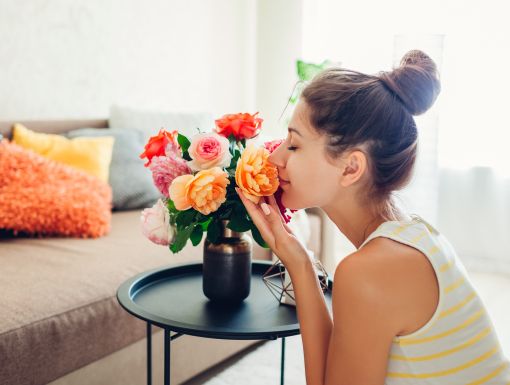 Woman smelling fresh flowers