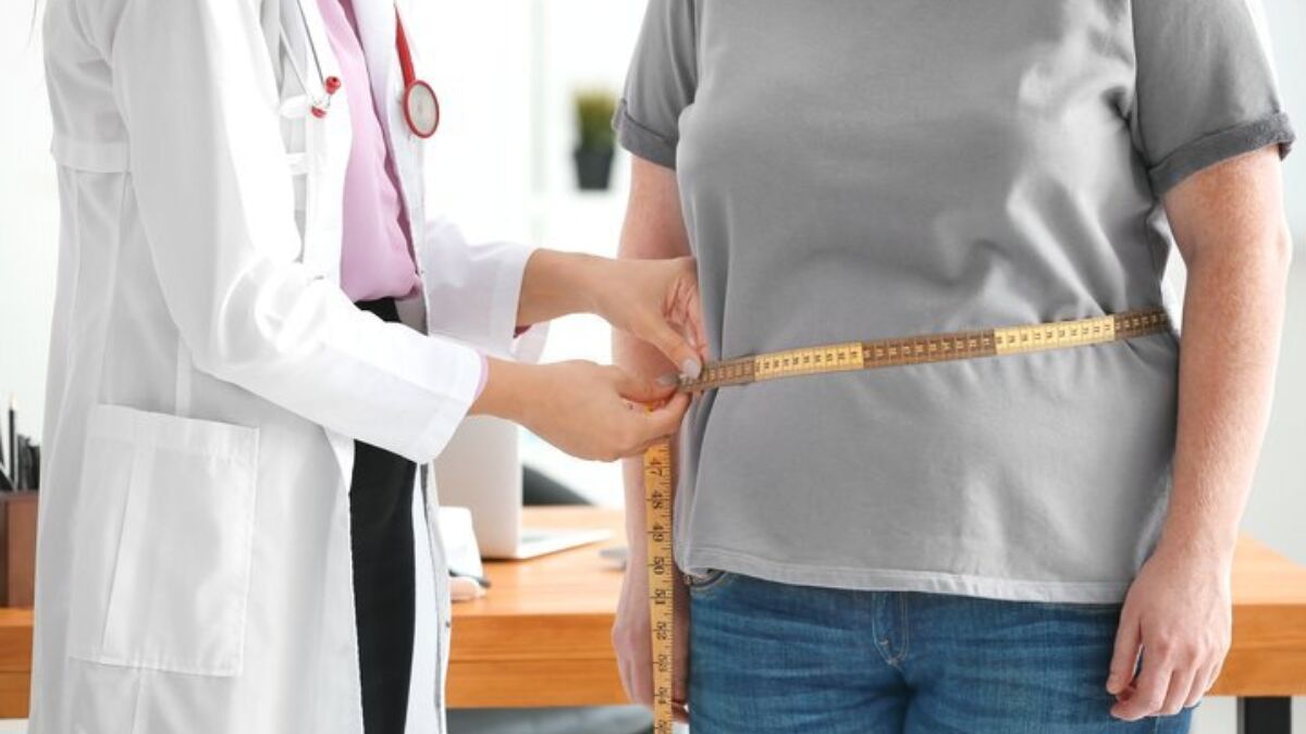 Provider measuring patients waist