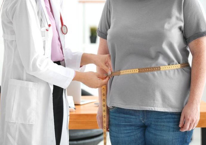 Provider measuring patients waist