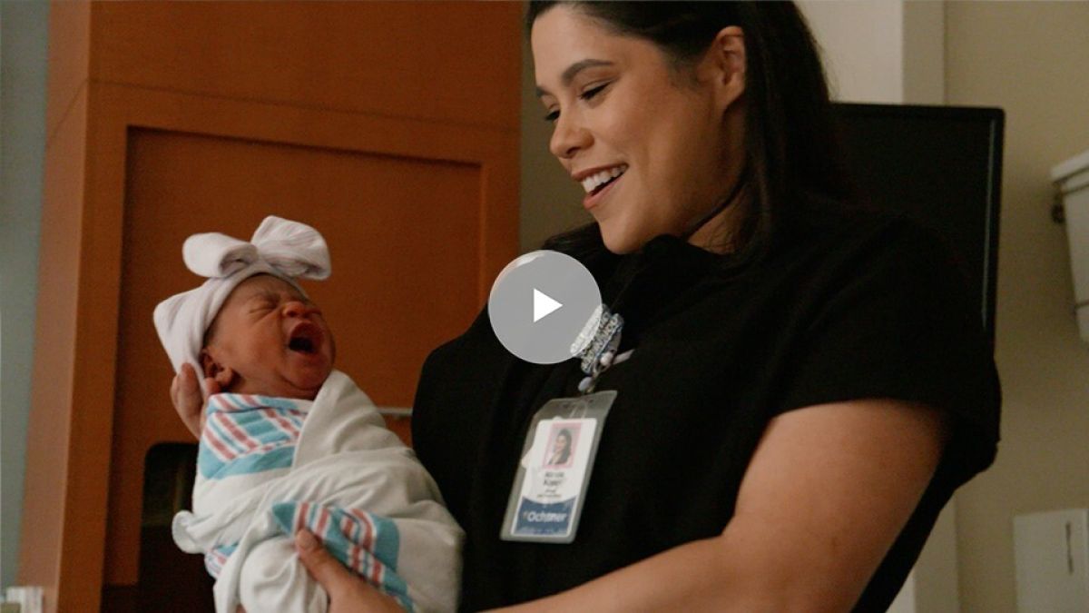 Midwife holding baby