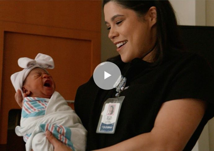 Midwife holding baby