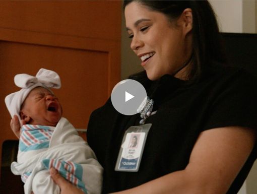 Midwife holding baby