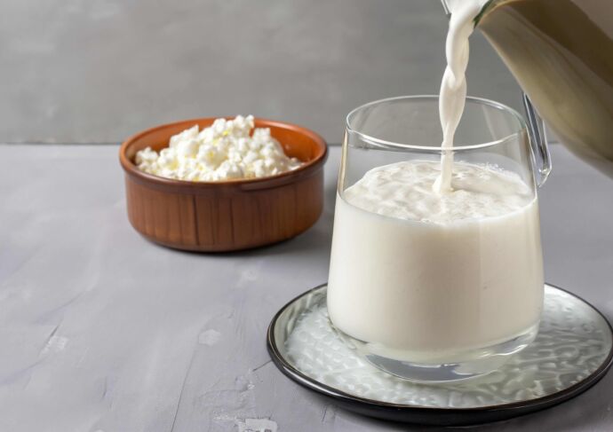 Milk for cottage cheese recipe pouring into glass