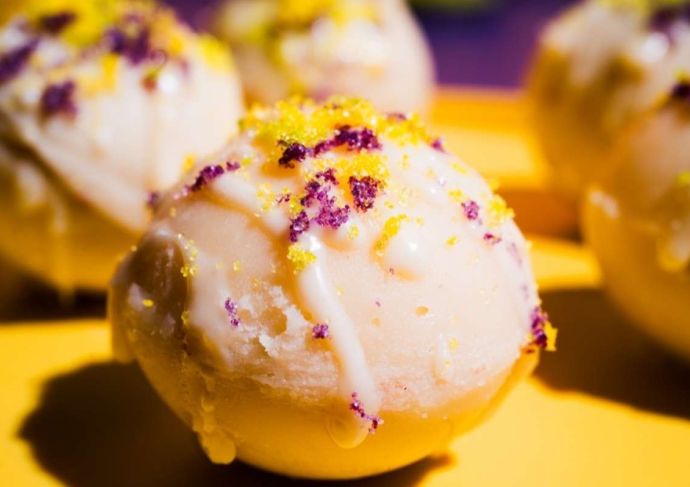 King Cake Hot Cocoa Bombs with purple and gold sugar