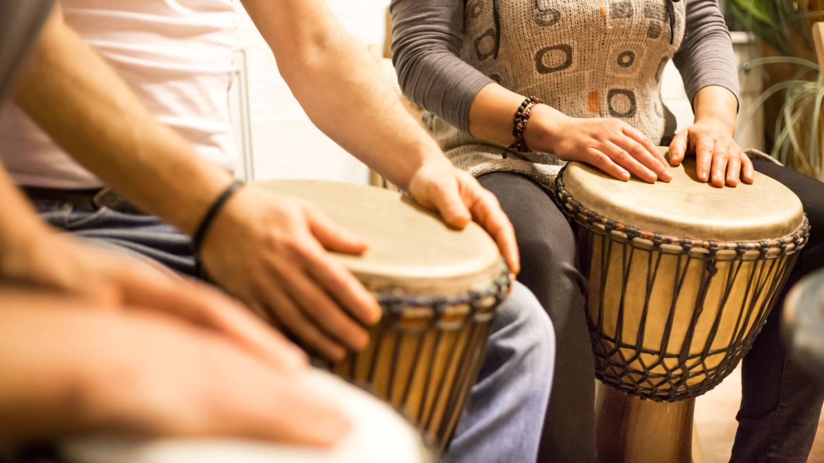 People playing drums in music therapy class