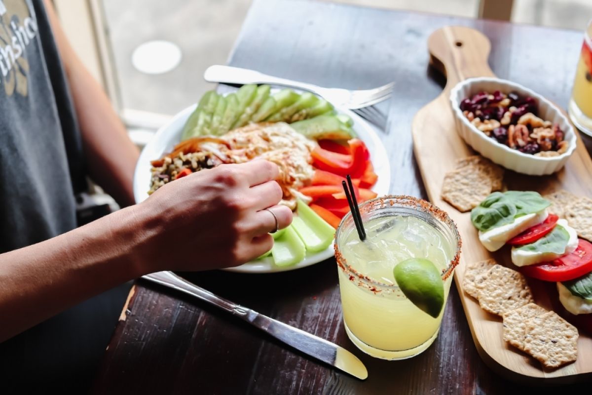 Close up of person sitting at table eating a healthy meal