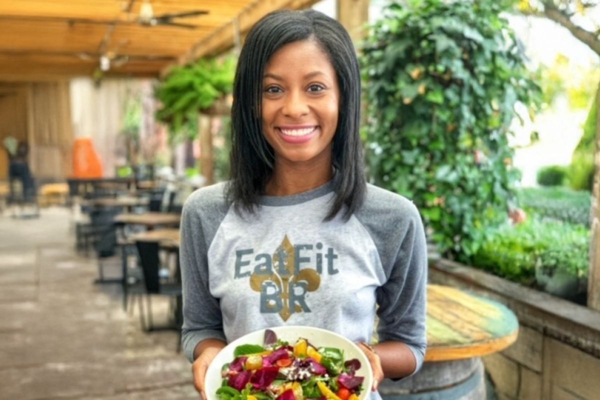 Eat Fit Ambassador smiling holding salad bowl