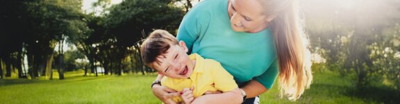 Mother son laughing outside