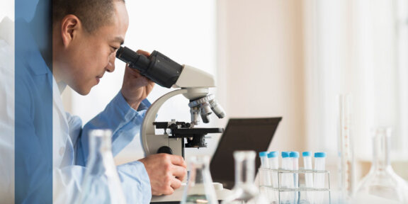 Doctor looking through a microscope