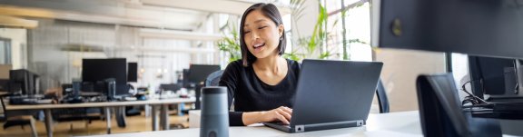 Woman on laptop using voice assistant