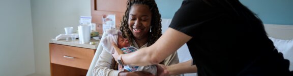 New mom holding baby after delivery