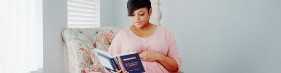 Pregnant mother reading pregnancy book