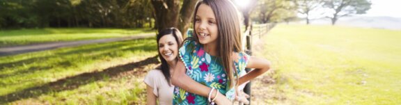 Happy mother and daughter outside