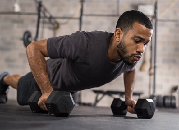 Man working out with weights in gym