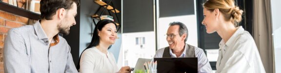 Diverse group of employees sitting at table